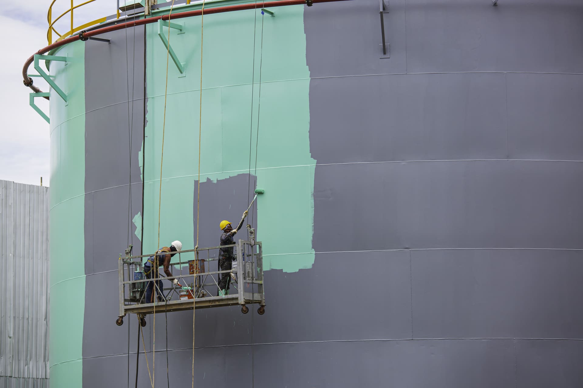 Painters working on a commercial building exterior in Florida